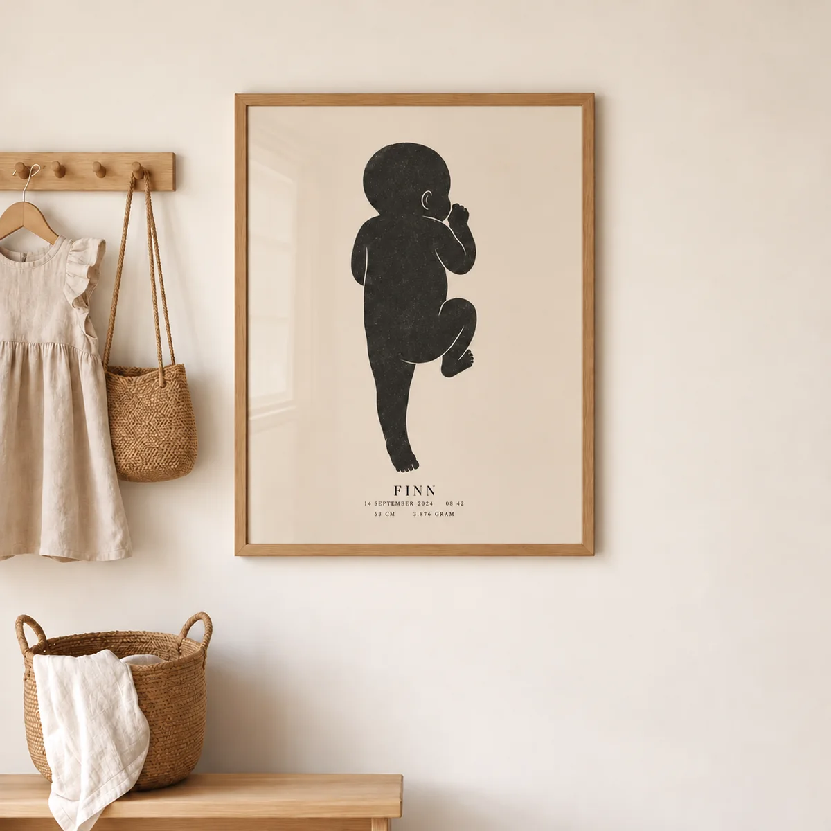Interieurvisualisatie van Geboorteposter met donker babysilhouet in eiken lijst aan de muur